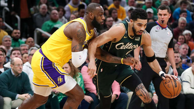 Lakers’ LeBron James tries to steal the ball from Celtics’ Jayson Tatum.